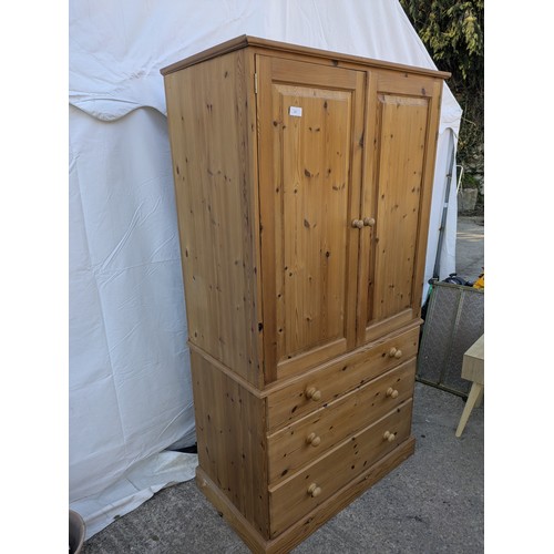 471 - A large pine upright wardrobe - 3 underlying drawers with a large wardrobe space and interior clothe... 