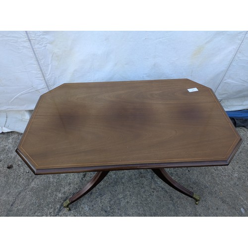 617 - Mahogany veneered antique styled occasional table. With brass lions paw casters.