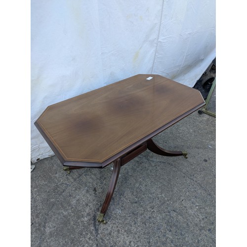 617 - Mahogany veneered antique styled occasional table. With brass lions paw casters.