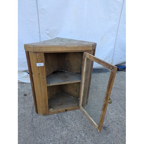 474 - A rustic glass fronted pine corner cabinet