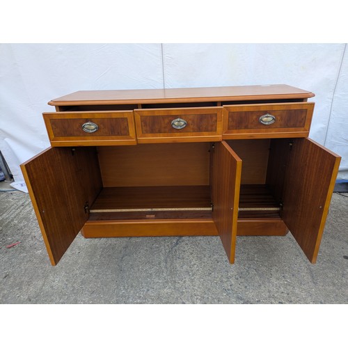 613 - A walnut verniered storage cabinet with three drawer and three storage spaces underneath.