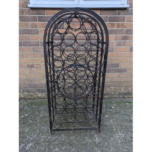 642 - A large antique 35 bottle wrought iron wine rack, with latching door and charming detail