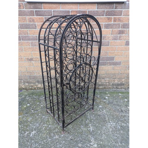 642 - A large antique 35 bottle wrought iron wine rack, with latching door and charming detail