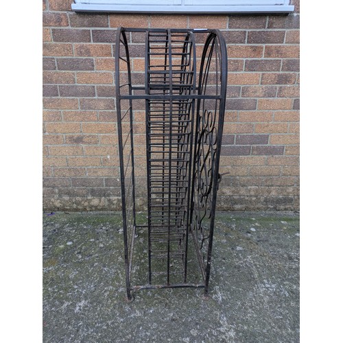 642 - A large antique 35 bottle wrought iron wine rack, with latching door and charming detail