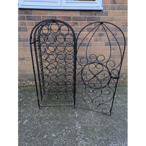 642 - A large antique 35 bottle wrought iron wine rack, with latching door and charming detail