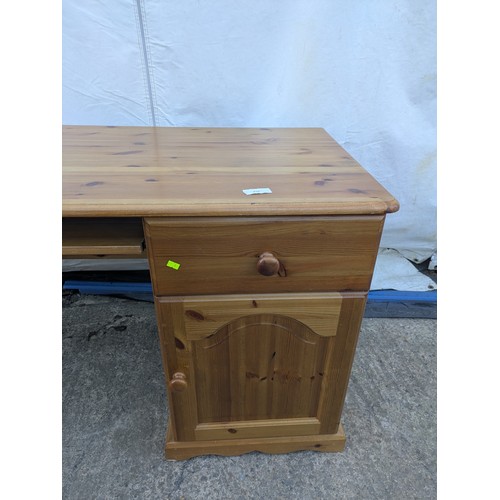 476 - A modern pine desk with cupboard and drawer space