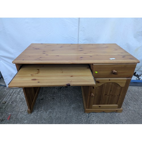 476 - A modern pine desk with cupboard and drawer space