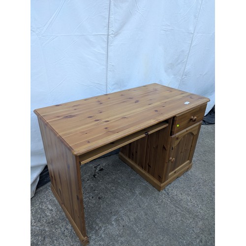 476 - A modern pine desk with cupboard and drawer space