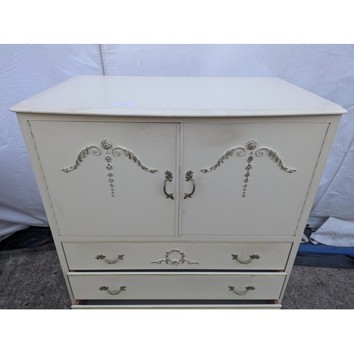 611 - An ornate renaissance style four drawer chest of drawers with storage cabinet on top.