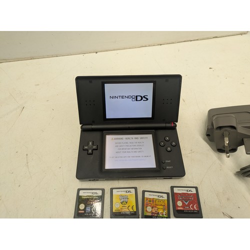 1493 - A Nintendo DS Lite black console and 4 games - powers on