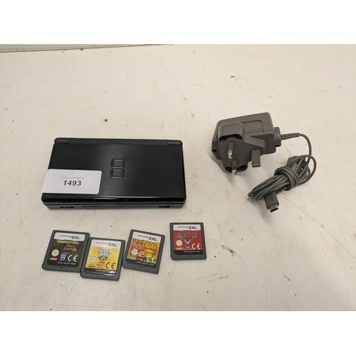 1493 - A Nintendo DS Lite black console and 4 games - powers on