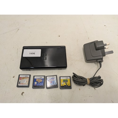 1496 - A Nintendo DS Lite black console and 4 games - powers on