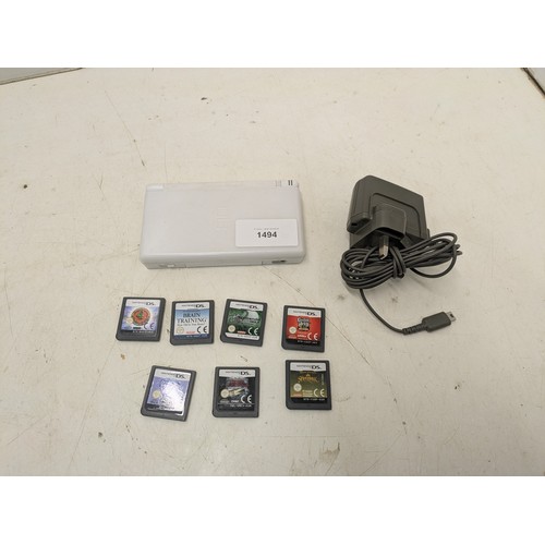 1494 - A Nintendo DS Lite white console and 7 games - powers on