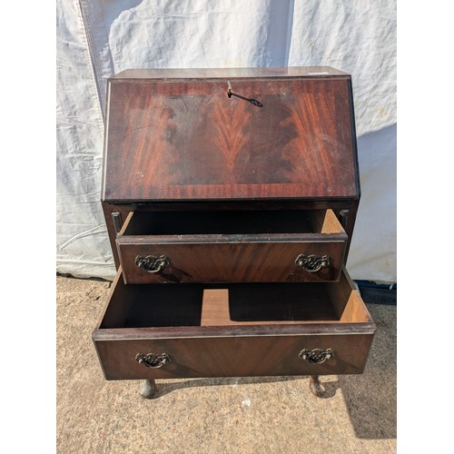 656 - An antique mahogany bureau with ornate carved legs, underlying drawers and interior compartments