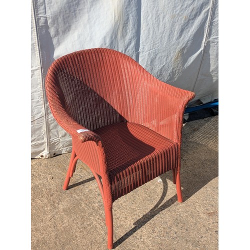 652 - A painted wicker armchair