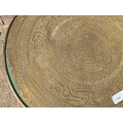 654 - A middle eastern style ornate brass topped side table with barley twist legs