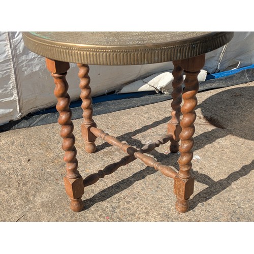 654 - A middle eastern style ornate brass topped side table with barley twist legs