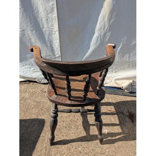 648 - An early 20th century oak captains chair