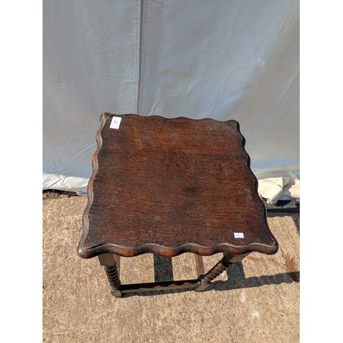 667 - An Oak side table with Bevelled top and barley twist legs