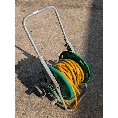 220 - Garden hose on a wheeled reel.