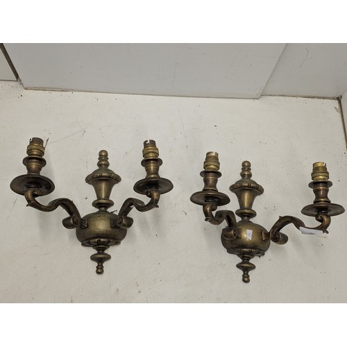 1091 - A pair of wall mounted heavy brass light fixtures