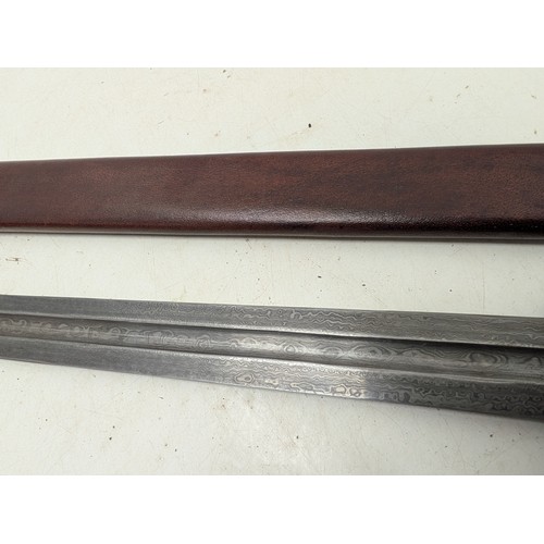 2116 - A Damascus steel sword in scabbard