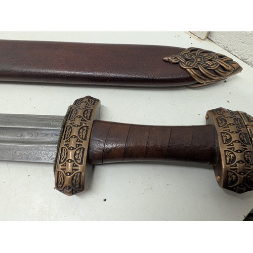 2116 - A Damascus steel sword in scabbard