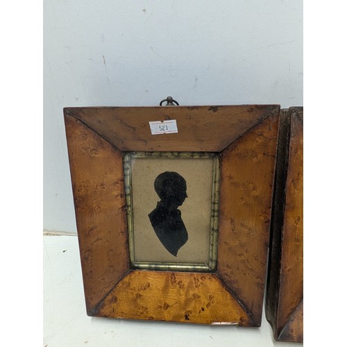 1093 - A pair of early 20th century silhouettes in walnut veneer frames