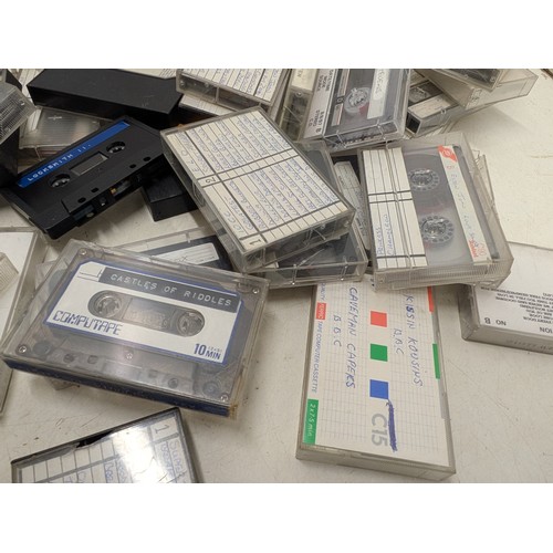 1513 - A large selection of cassettes for use with Zx spectrum and a selection of music cassettes