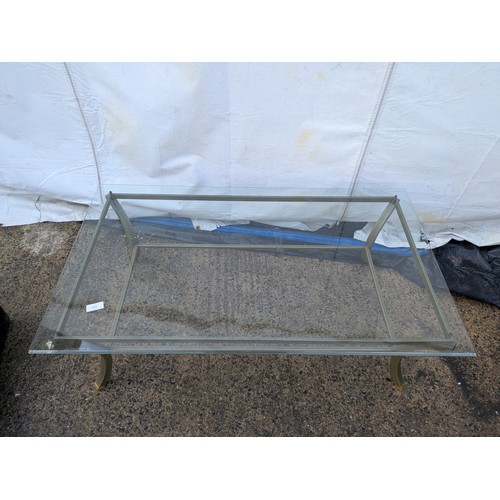 413 - A metal framed glass topped coffee table