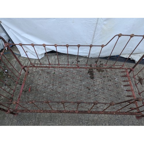 468 - A Victorian wrought iron collapsible cot bed