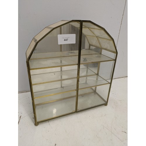 447 - A small brass and glass display unit