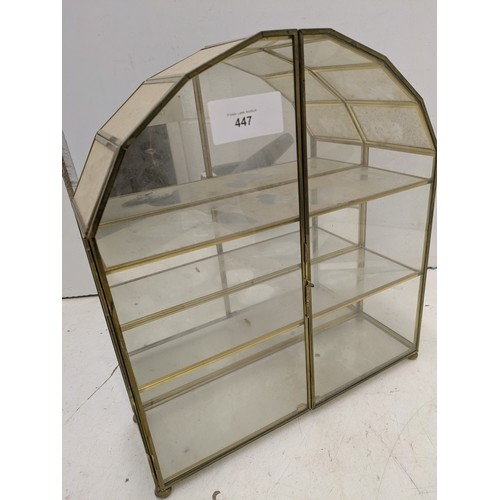 447 - A small brass and glass display unit