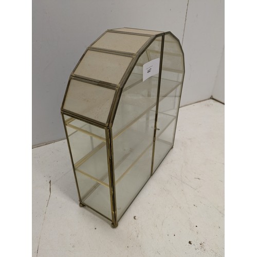 447 - A small brass and glass display unit