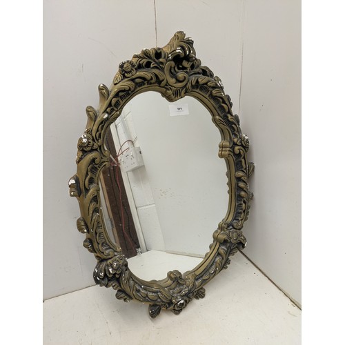 446 - A stylish ornate wall mounted mirror