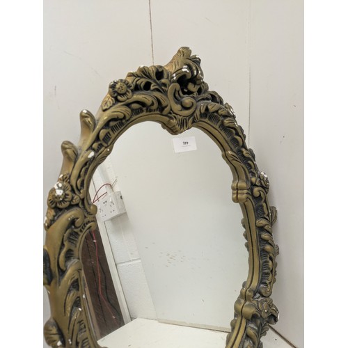 446 - A stylish ornate wall mounted mirror