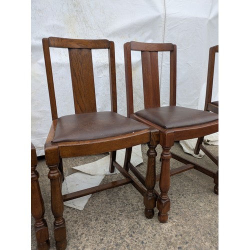 449 - A set of 4 oak dining chairs with leather seat bases