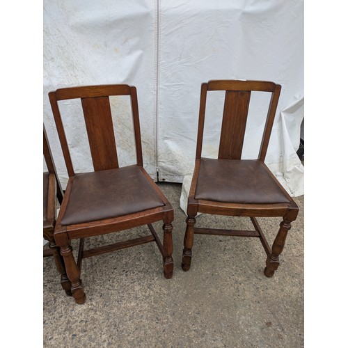 449 - A set of 4 oak dining chairs with leather seat bases