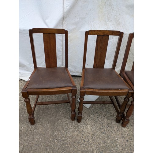 449 - A set of 4 oak dining chairs with leather seat bases