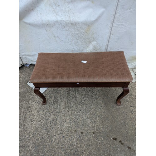 463 - A vintage piano stool with a seated fabric base and internal storage