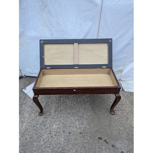 463 - A vintage piano stool with a seated fabric base and internal storage