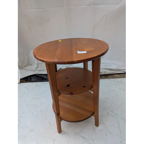 426 - A pine side table with underlying shelves