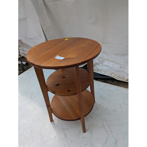 426 - A pine side table with underlying shelves