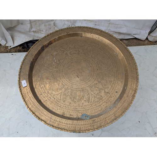 454 - An oriental brass tray table with stand