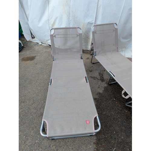 52 - A pair of metal framed collapsible sun loungers