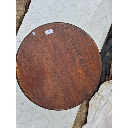 459 - An early 20th century oak circular table with lions paw fer