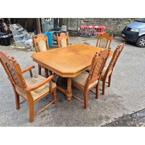 413 - A large oak dining table with 6 dining chairs - nicely carved with a cream fabric padded upholstery