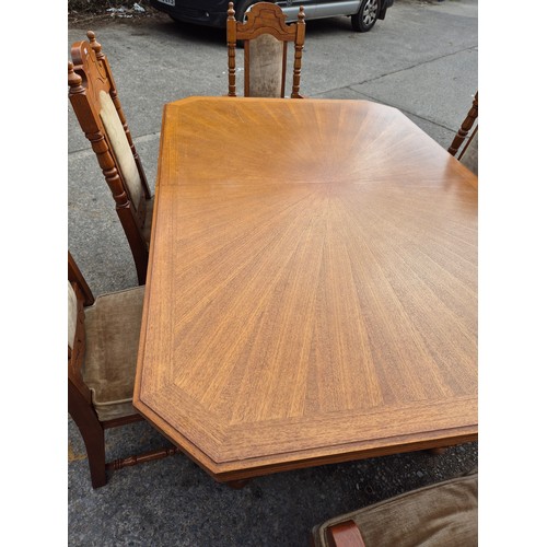 413 - A large oak dining table with 6 dining chairs - nicely carved with a cream fabric padded upholstery