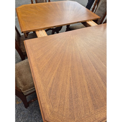 413 - A large oak dining table with 6 dining chairs - nicely carved with a cream fabric padded upholstery