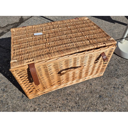 470 - A wicker basket with leather straps